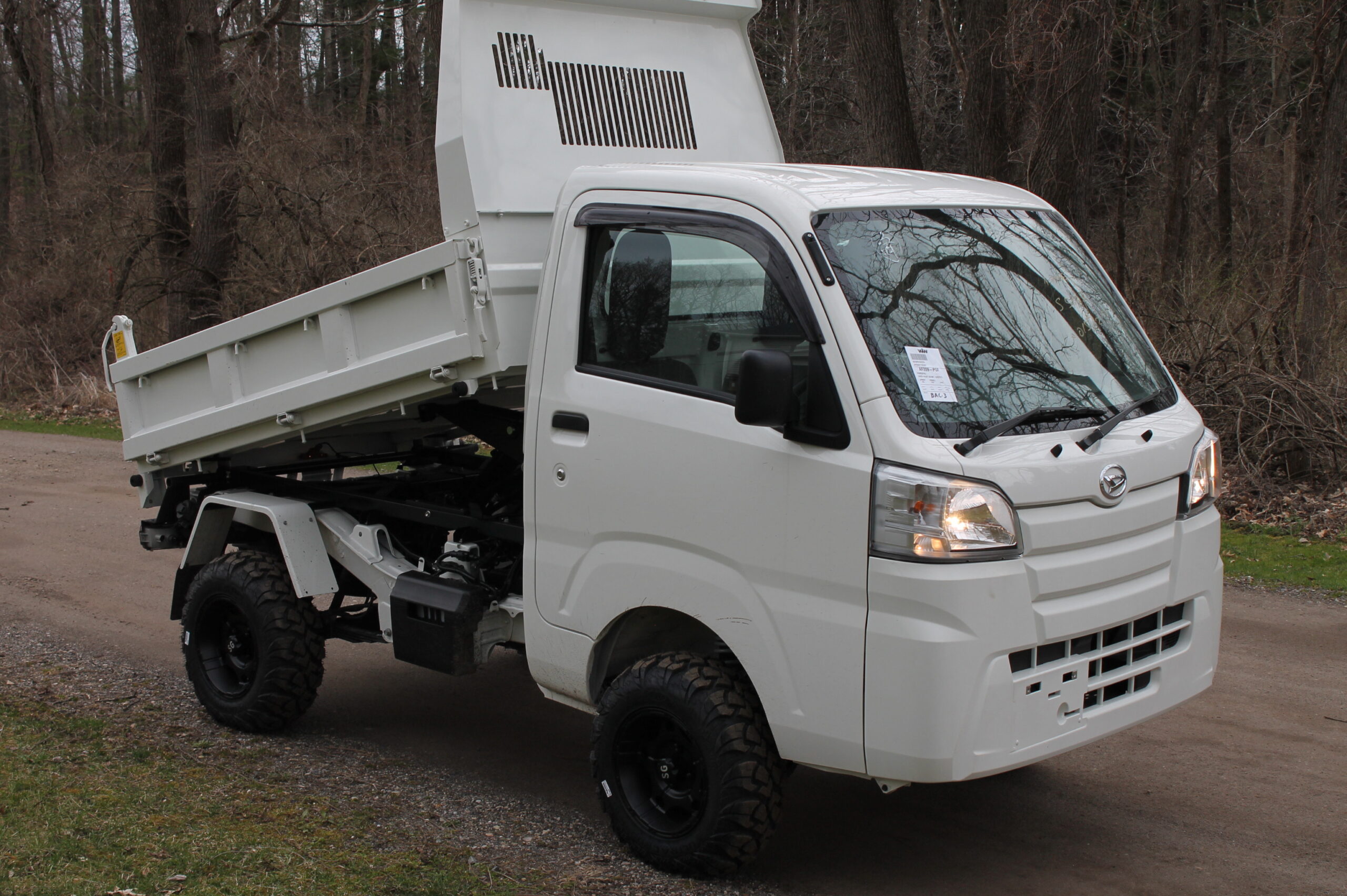 New Daihatsu HD Dump with bed raised from left front